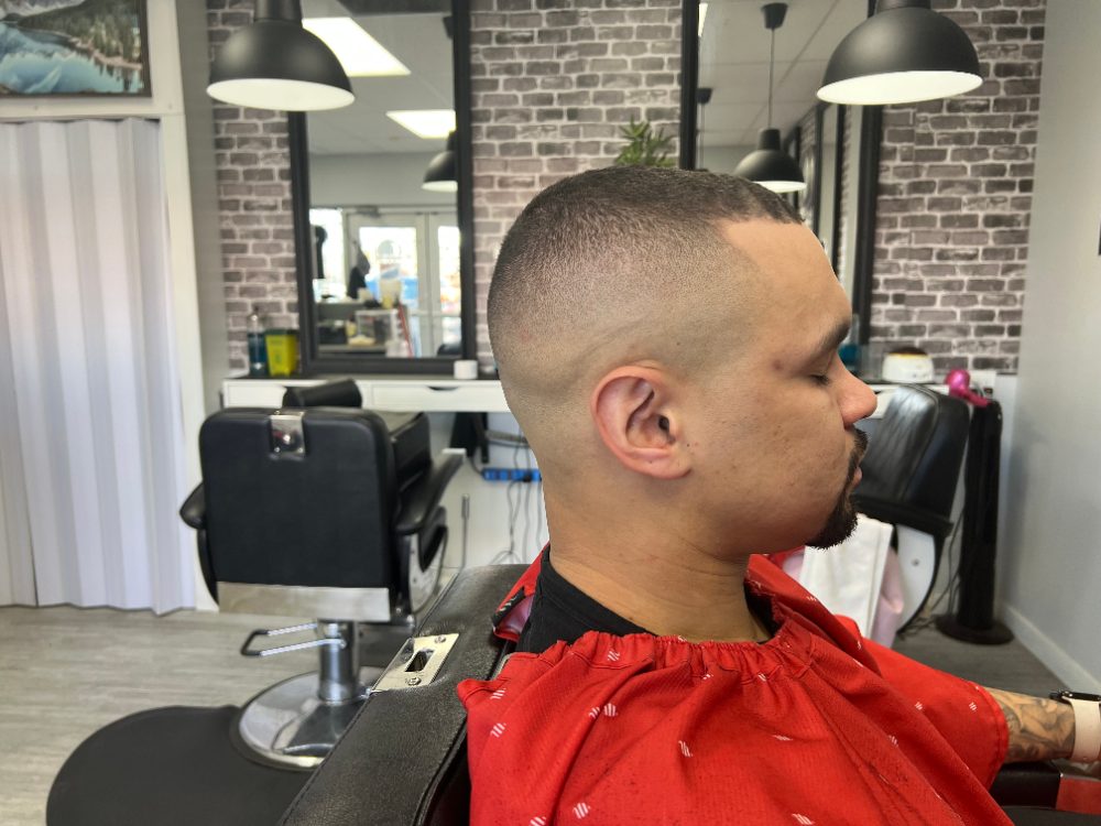 High skin fade with a lined-up beard